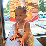 Jordynn joined the competition — help win amazing prizes! bench, burger, child, clothing, curly_hair, cute, daylight, fast_food, fries, hair_style, hand, indoor, person, poster, restaurant, skin, smiling, table, toddler, window