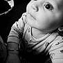 Allie is registered to the contest to win money with this photo: baby, child, face, portrait, black_and_white, onesie, bracelet, indoor, curious, wide_eyes, infant, cute, close_up, gazing, soft_light, sitting, furniture, baby_walker, monochrome, expression