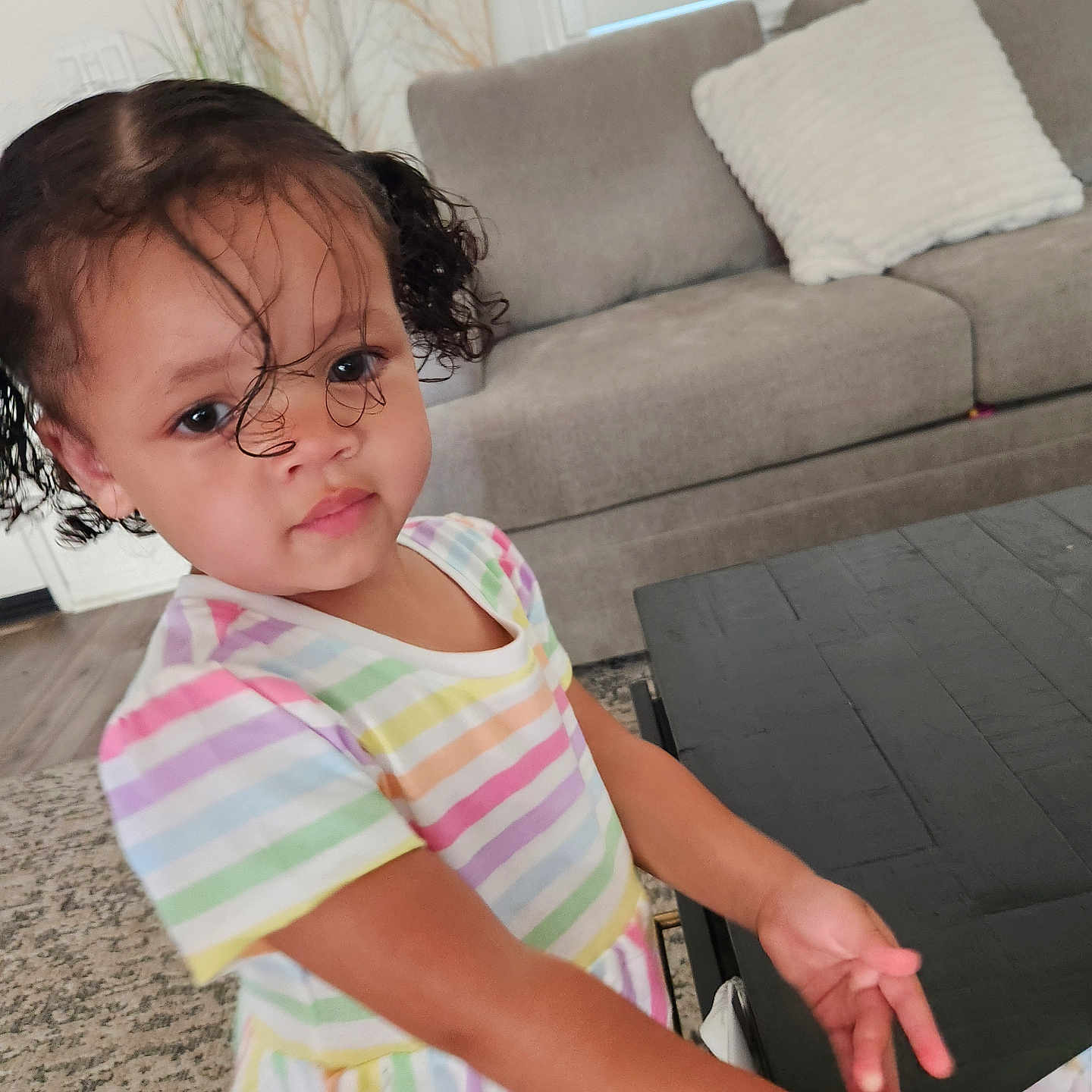 Amilliana joined the competition — help win amazing prizes! carpet, child, colorful_clothing, couch, curly_hair, cute, face, furniture, hair, home_decor, indoor, living_room, person, pigtails, plant, portrait, striped_dress, table, toddler, young_child