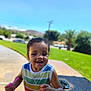 toddler, child, smiling, outdoor, daylight, grass, sky, bubble, toy, playing, happy, colorful_clothing, tank_top, wet_hair, person, park, concrete, bench, sunny, nature
