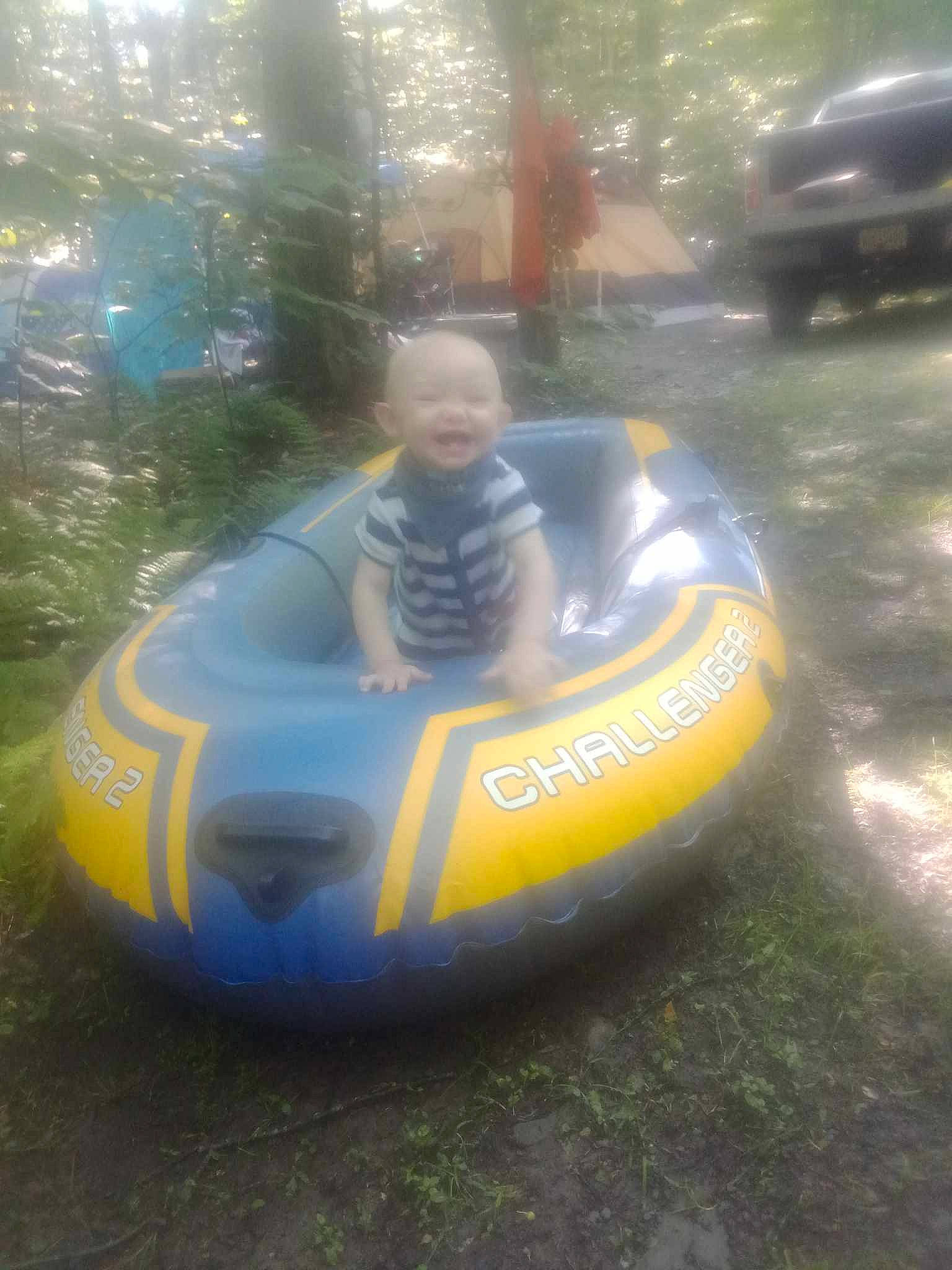 Winchester is registered to the contest to win money with this photo: automotive_design, automotive_exterior, automotive_lighting, automotive_tire, automotive_wheel_system, bumper, fun, grass, happy, inflatable, leisure, motor_vehicle, person, personal_protective_equipment, play, recreation, smile, sports_gear, toddler, toy