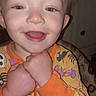 Donald is registered to the contest to win money with this photo: toddler, child, smiling, face, hands, onesie, halloween, skull, bat, pumpkin, indoor, baby, person, clothing, happy, portrait, cute, young_child, expression, cozy