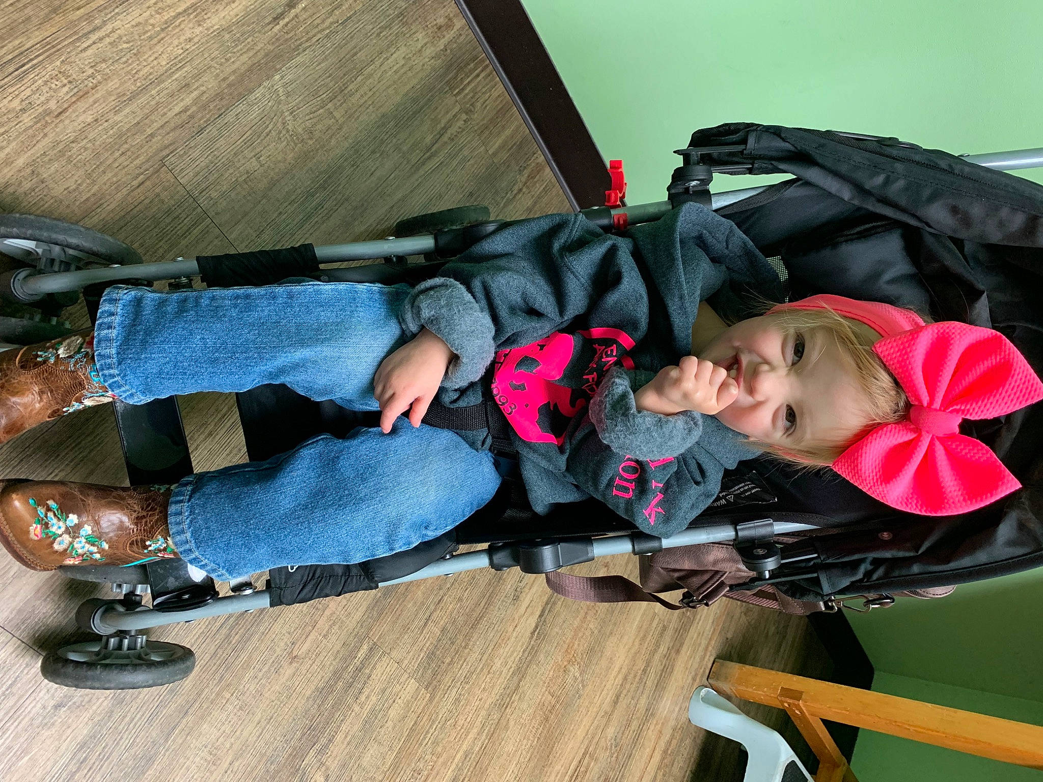Nevaeh is registered to the contest to win money with this photo: baby_products, boot, carmine, child, comfort, denim, fun, hardwood, headwear, leisure, outdoor_shoe, person, recreation, sitting, toddler, tree, walking_shoe, wood