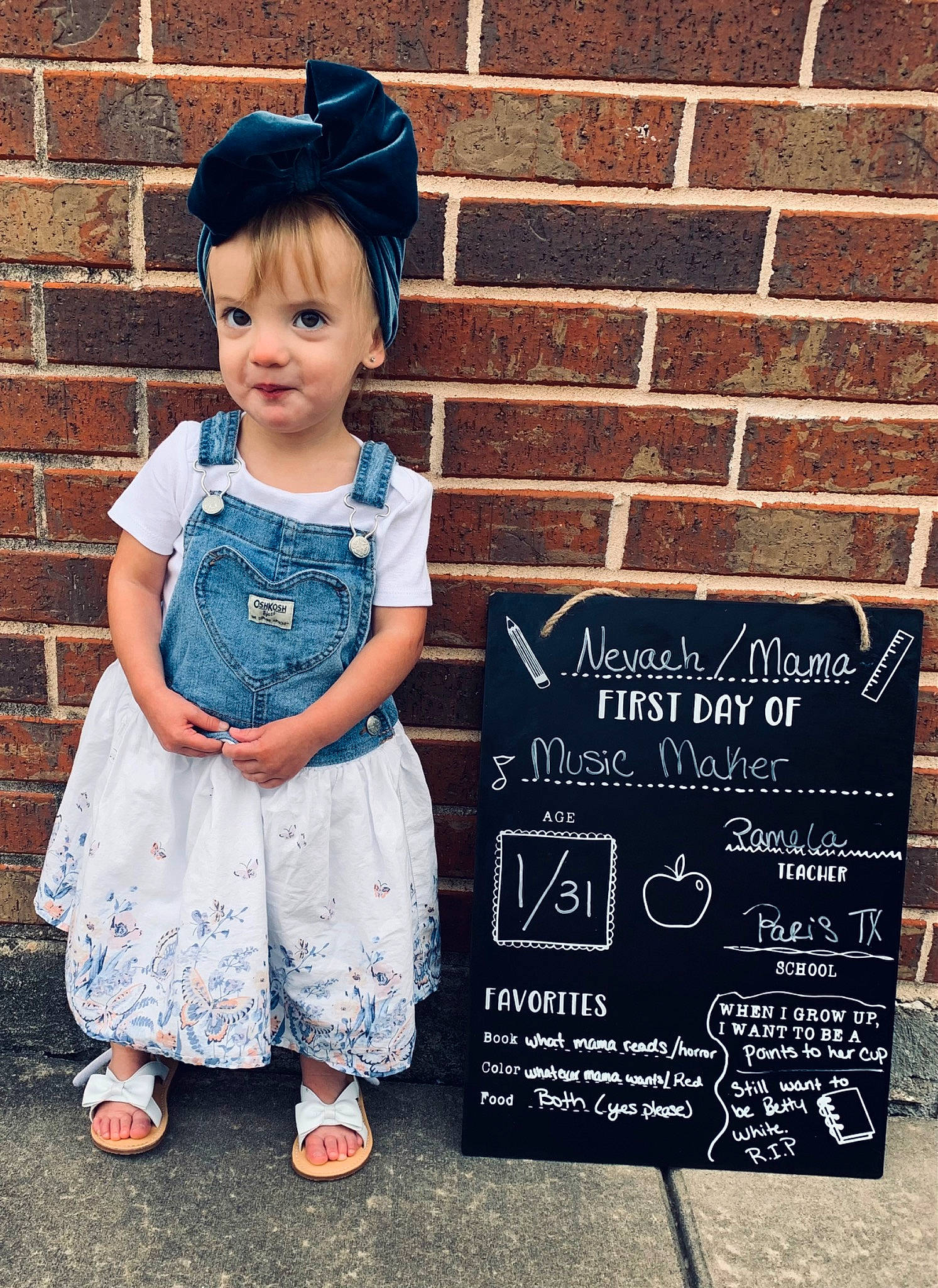Nevaeh is registered to the contest to win money with this photo: baby_toddler_clothing, blackboard, blue, chalk, child, cool, electric_blue, fashion_accessory, font, handwriting, happy, hat, headgear, magenta, pattern, person, sandal, sleeve, smile, toddler