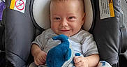 Jaimalyn is registered to the contest to win money with this photo: baby, blanket, blue, car_seat, child, clothing, comfort, cozy, cute, indoor, infant, pattern, person, plush_toy, portrait, sitting, smile, toy, white, wood_floor