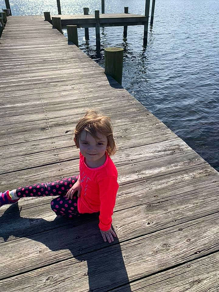 Lily joined the competition — help win amazing prizes! dock, floor, flooring, fun, hand, human_body, human_leg, joy, lake, leg, leisure, line, morning, person, recreation, summer, sunglasses, toddler, tree, walkway
