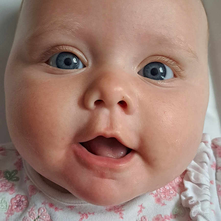 Arianwen joined the competition — help win amazing prizes! baby, blanket, blue_eyes, child, closeup, clothing, cute, expression, face, floral_pattern, head, infant, open_mouth, person, polka_dot, portrait, skin, smile, white_outfit, young