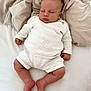 baby, sleeping, knitted_clothing, white_outfit, blanket, soft_texture, infant, peaceful, cozy, cute, resting, newborn, indoors, relaxation, portrait, child, skin, hand, foot, head