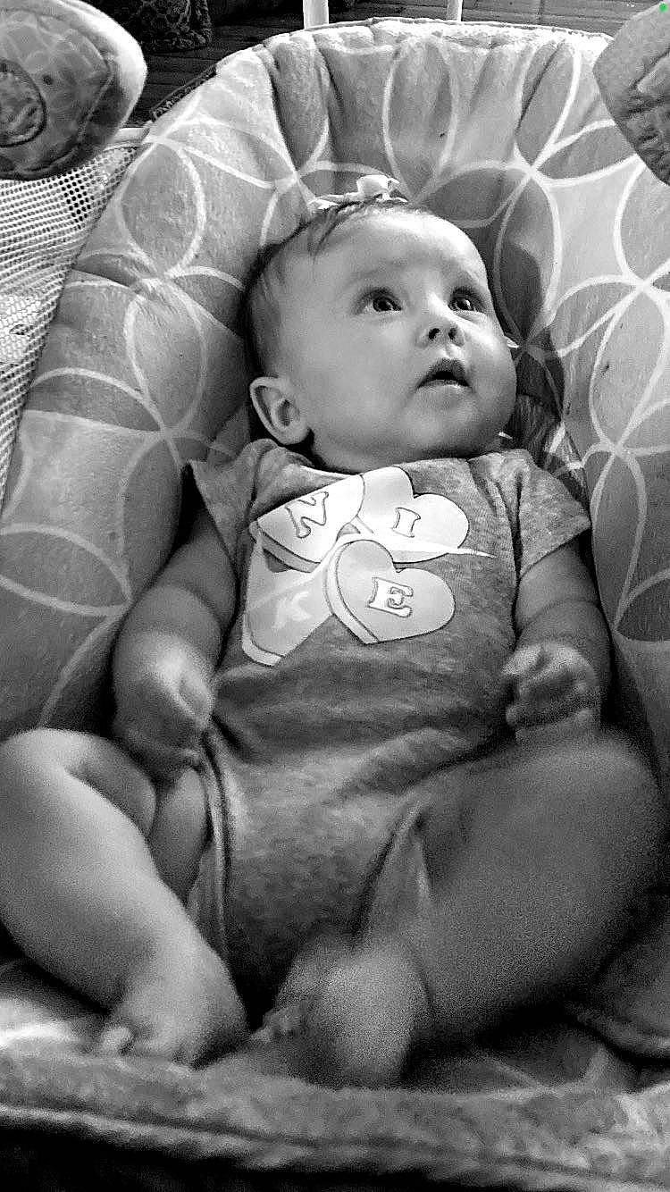 Nevaeh is registered to the contest to win money with this photo: arm, baby, baby_toddler_clothing, black, cheek, chin, comfort, eye, face, flash_photography, head, human_body, iris, lip, mouth, person, photograph, skin, sleeve, style