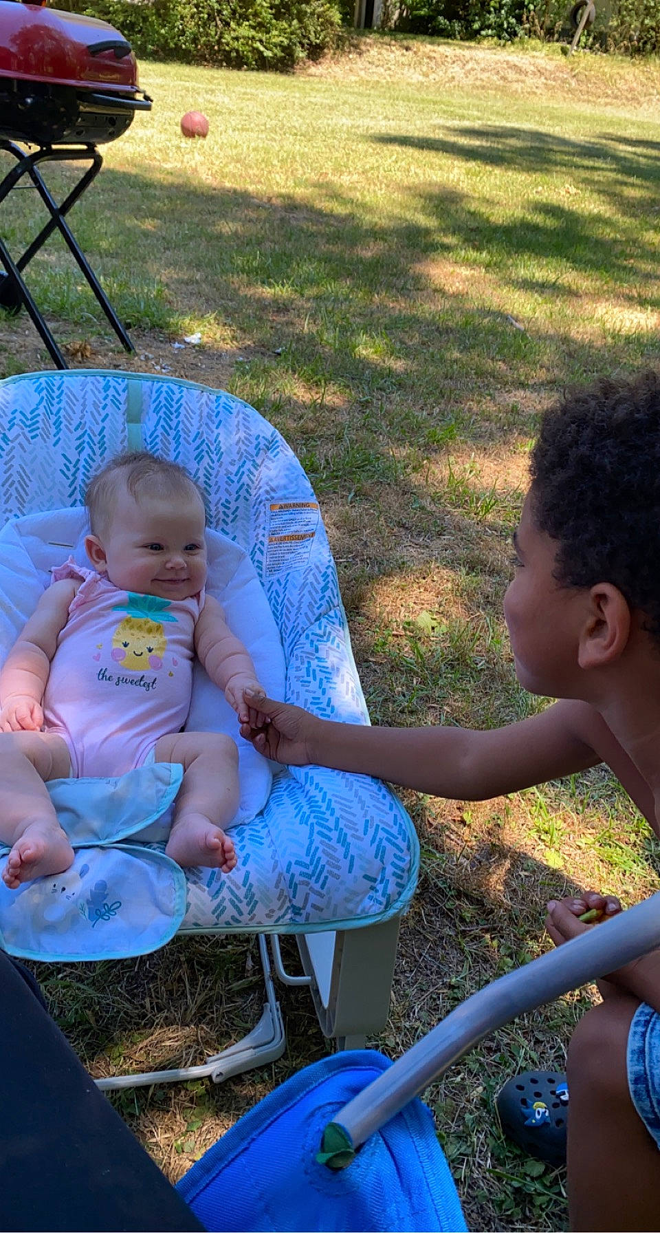 Nevaeh joined the competition — help win amazing prizes! baby, baby_toddler_clothing, blue, chair, child, fun, grass, happy, joy, lap, lawn, leisure, mammal, outdoor_furniture, people_in_nature, person, public_space, recreation, shorts, sitting