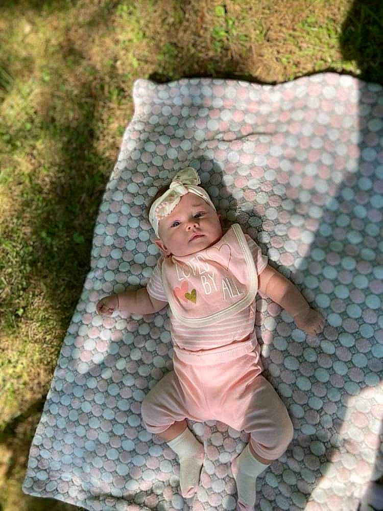 Nevaeh joined the competition — help win amazing prizes! baby_toddler_clothing, child, face, fashion_accessory, fawn, fun, grass, happy, headwear, leaf, pattern, peach, people_in_nature, person, play, portrait_photography, recreation, sitting, sleeve, toddler