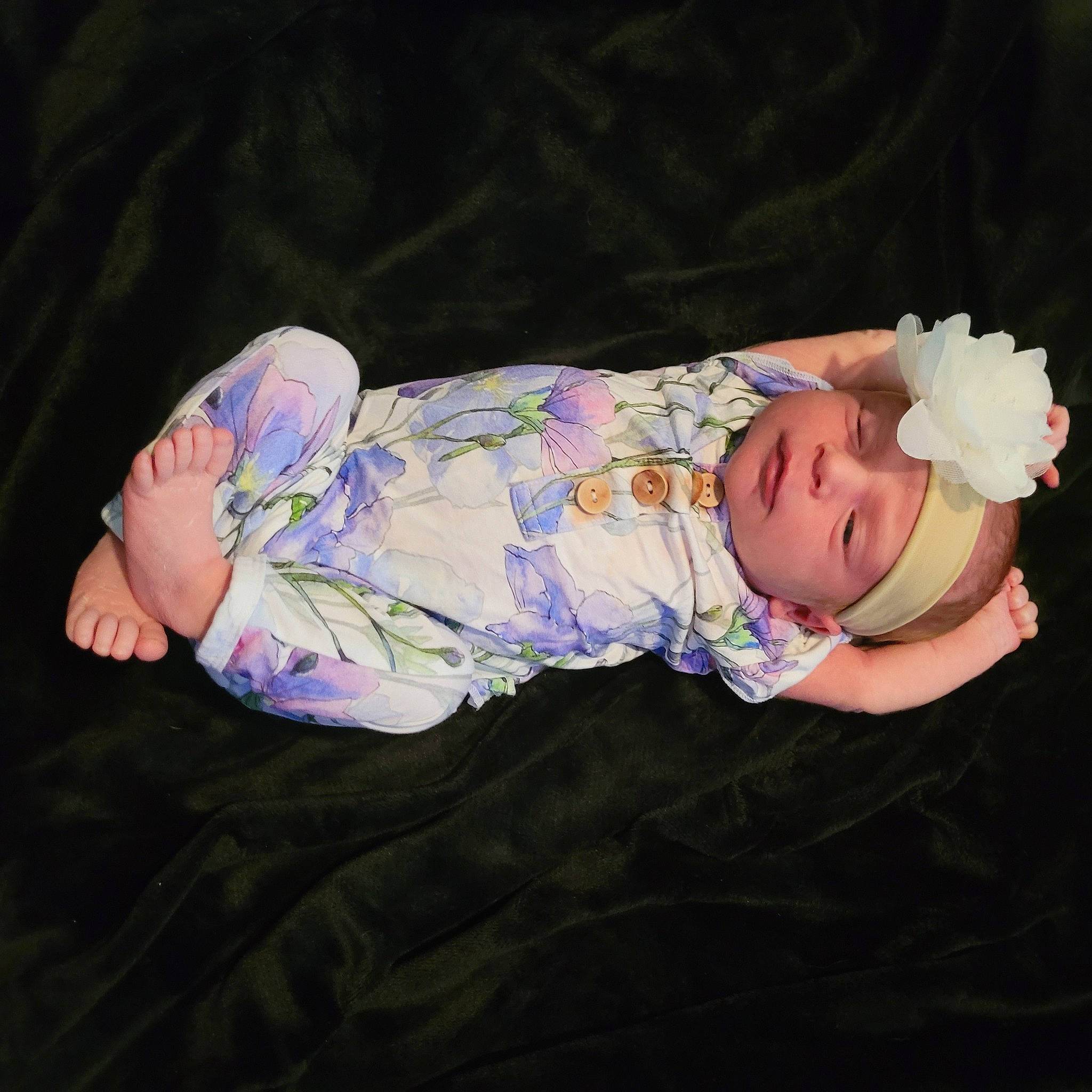 Celine is registered to the contest to win money with this photo: baby, baby_products, baby_toddler_clothing, cheek, child, comfort, flash_photography, grass, hat, headwear, nap, pattern, person, plant, rose, sitting, sleeve, sock, toddler, tree