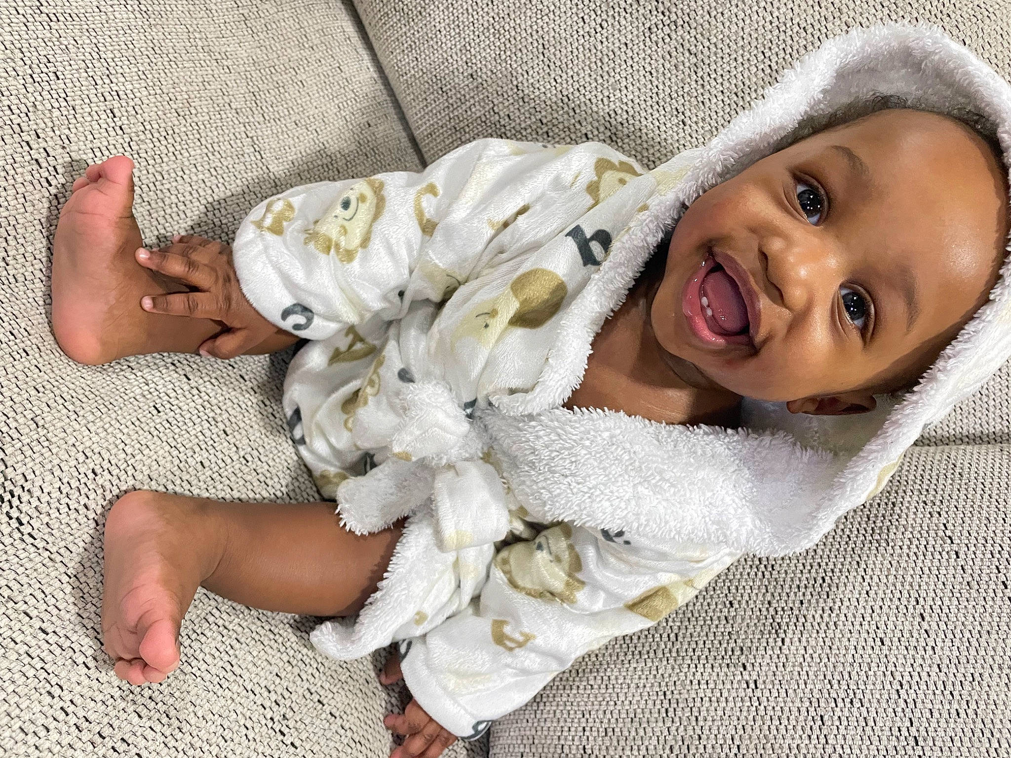 Jamal is registered to the contest to win money with this photo: baby, baby_toddler_clothing, cheek, child, comfort, dress, face, fashion_accessory, foot, fun, fur, happy, head, human_body, human_leg, mammal, person, skin, smile, thigh