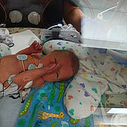 Julian joined the competition — help win amazing prizes! newborn, baby, incubator, hospital, medical_equipment, blanket, animal_print, heart_pattern, monitoring_wires, tiny, premature, swaddled, infant, healthcare, child, bed, nurse_arm, care, patient, neonatal