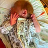 newborn, baby, sleeping, infant, hospital, bracelet, onesie, animal_print, blanket, pillow, bed, peaceful, cute, child, person, indoors, rest, face, hand, skin