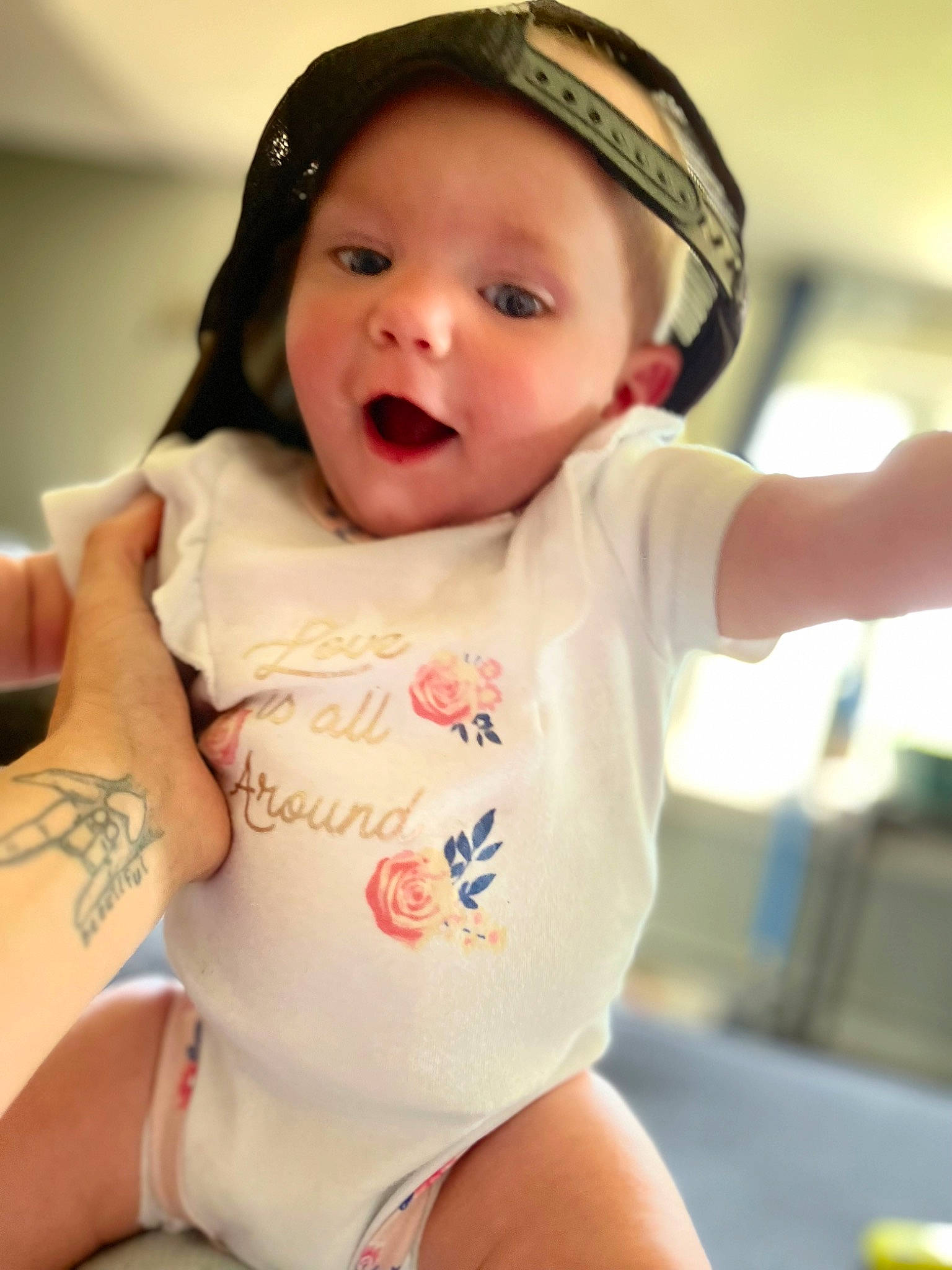 Lylah is registered to the contest to win money with this photo: abdomen, baby, baby_toddler_clothing, cheek, elbow, eyelash, finger, gesture, happy, headwear, lip, mouth, neck, person, skin, sleeve, smile, t_shirt, thigh, toddler