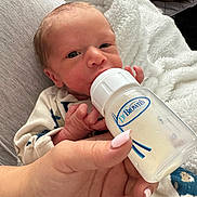 Brayden joined the competition — help win amazing prizes! baby, newborn, bottle, feeding, hand, nails, blanket, clothing, person, infant, milk, closeup, cute, indoors, soft, resting, care, parent, feeding_bottle, comfort