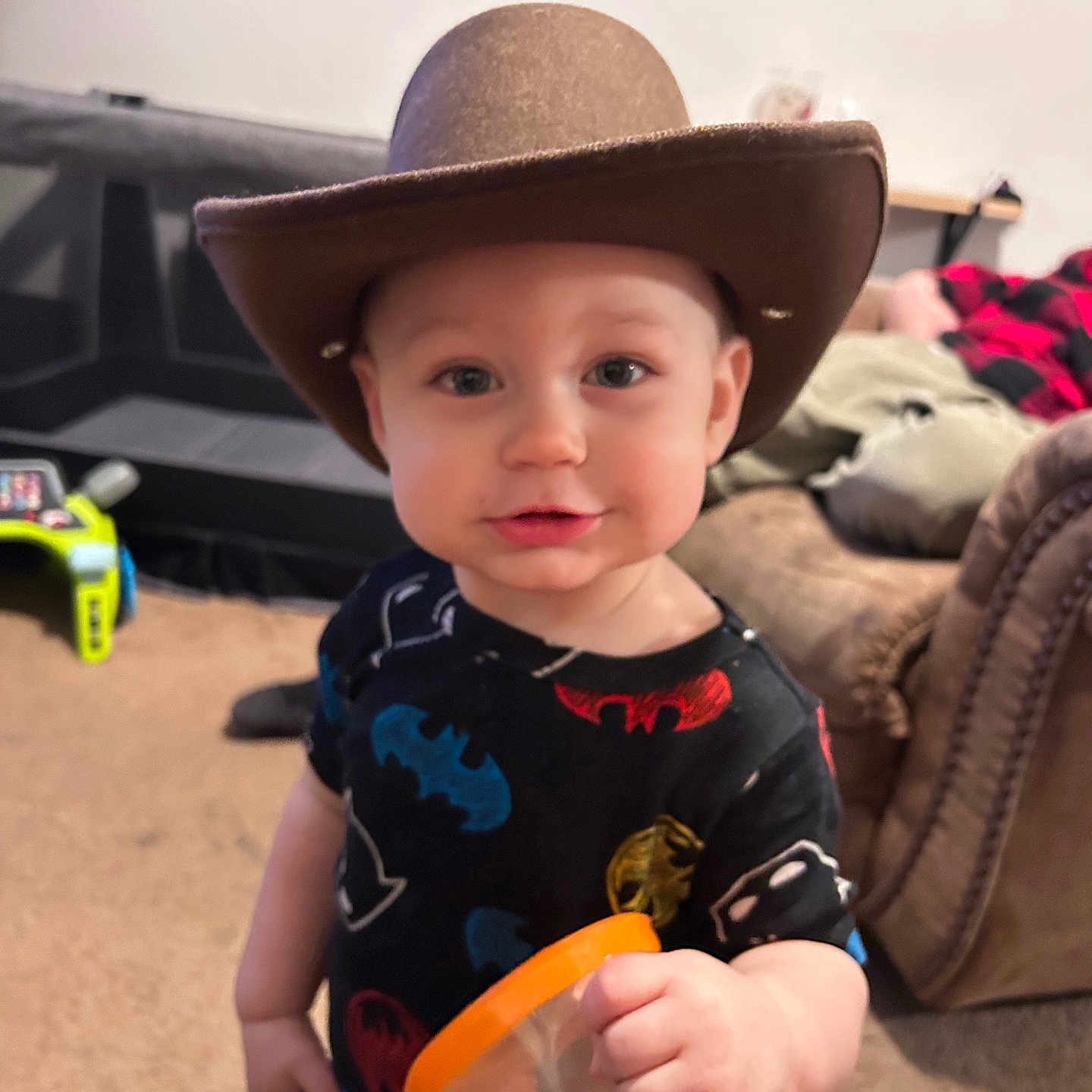 Levi is registered to the contest to win money with this photo: baby, bodypart, car, clothing, couch, cup, face, finger, footwear, furniture, hand, hat, head, person, photography, portrait, shoe, sunhat, transportation, vehicle