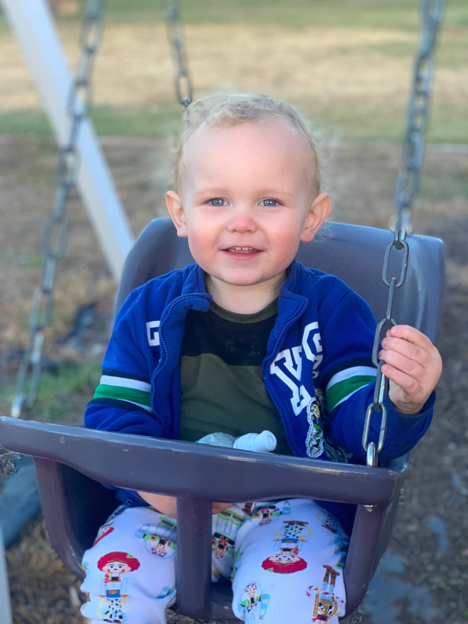 Tristan joined the competition — help win amazing prizes! child, chin, city, electric_blue, eye, facial_expression, fun, grass, hairstyle, hand, happy, head, joy, leisure, outdoor_play_equipment, person, recreation, skin, smile, swing