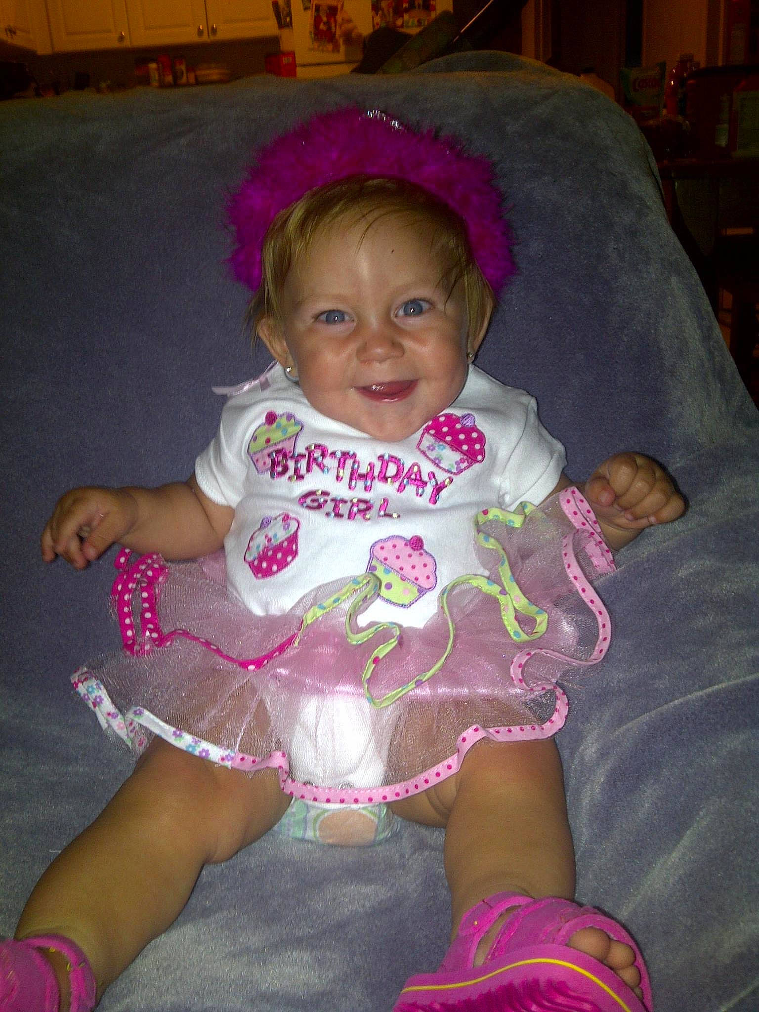 Sallie is registered to the contest to win money with this photo: baby_toddler_clothing, cheek, clothing, dress, eye, face, happy, head, iris, joy, leg, magenta, organ, person, pink, product, purple, skin, smile, textile