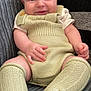 Milan is registered to the contest to win money with this photo: baby, child, chubby_cheeks, couch, cute, eyes, hands, happy, head, indoor, infant, knee_socks, knitted_clothing, legs, overalls, portrait, seated, smiling, soft_texture, striped