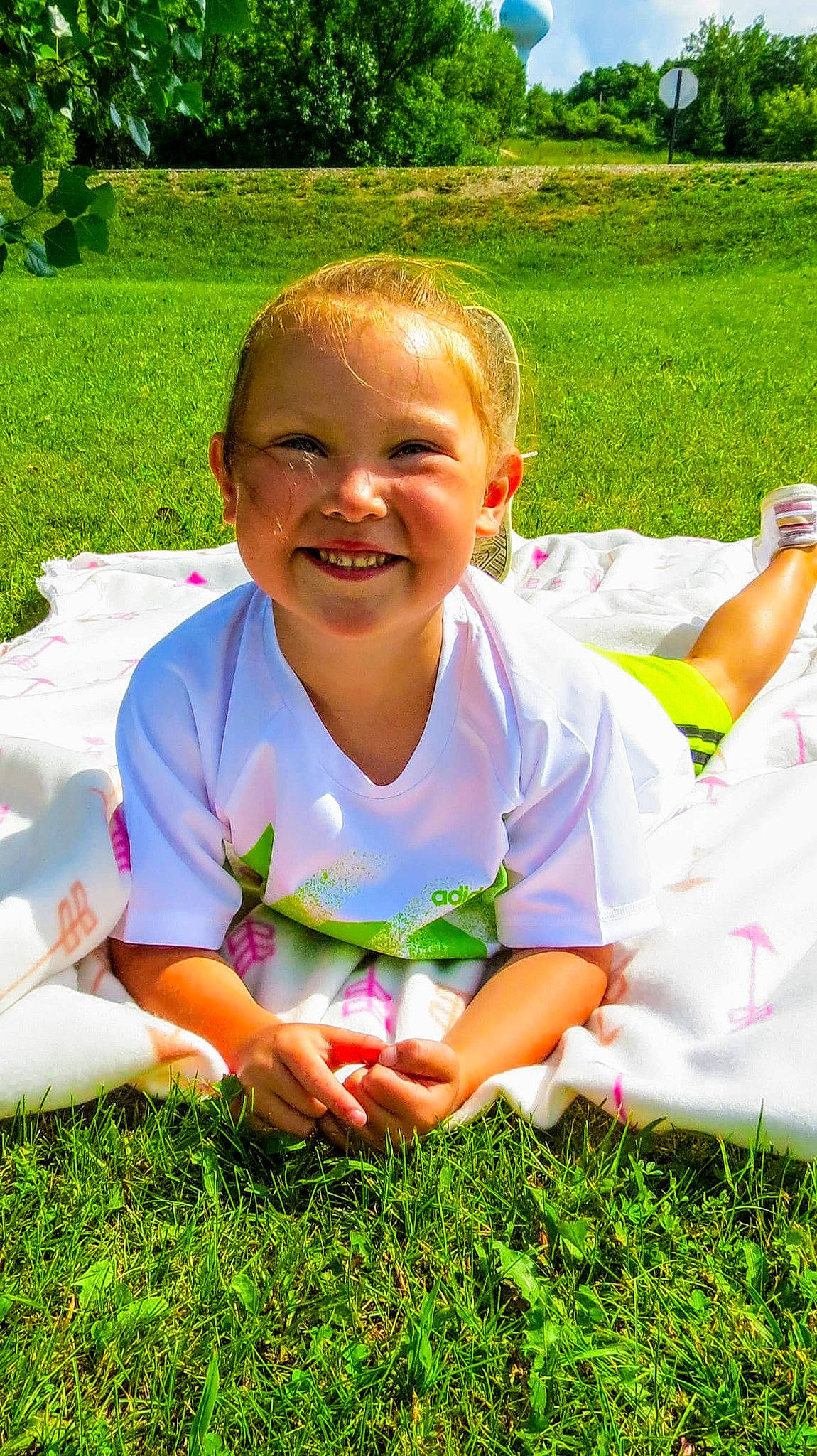 Aubree is registered to the contest to win money with this photo: botany, facial_expression, finger, fun, grass, green, happy, human_body, joy, leaf, leisure, nature, people_in_nature, person, plant, public_space, recreation, smile, summer, sunlight