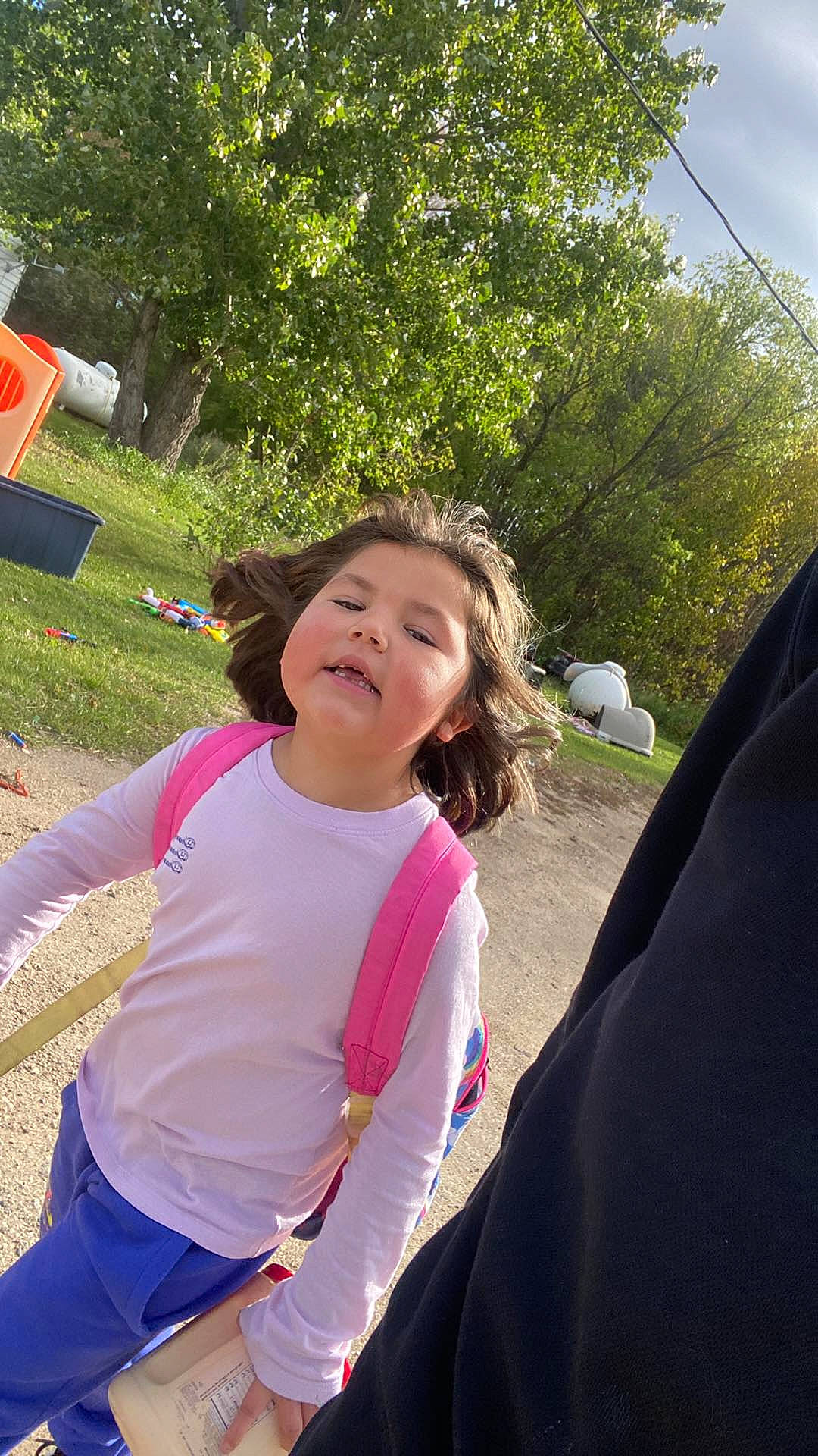 Brayleigh is registered to the contest to win money with this photo: event, fun, grass, happy, leaf, leisure, magenta, outdoor_play_equipment, person, pink, plant, play, recreation, soil, spring, summer, swing, t_shirt, toddler, tree