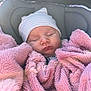 baby, newborn, sleeping_baby, blanket, pink_blanket, beanie, striped_hat, car_seat, closed_eyes, lips, face, cozy, soft_texture, portrait, infant, napping, clothing, closeup, candid, peaceful