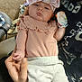 baby, infant, bow_headband, floral_bow, pink_outfit, ruffles, mittens, adult, hand, holding_hand, blanket, carpet, portrait, indoor, newborn, cute, family, onesie, sitting, closeup