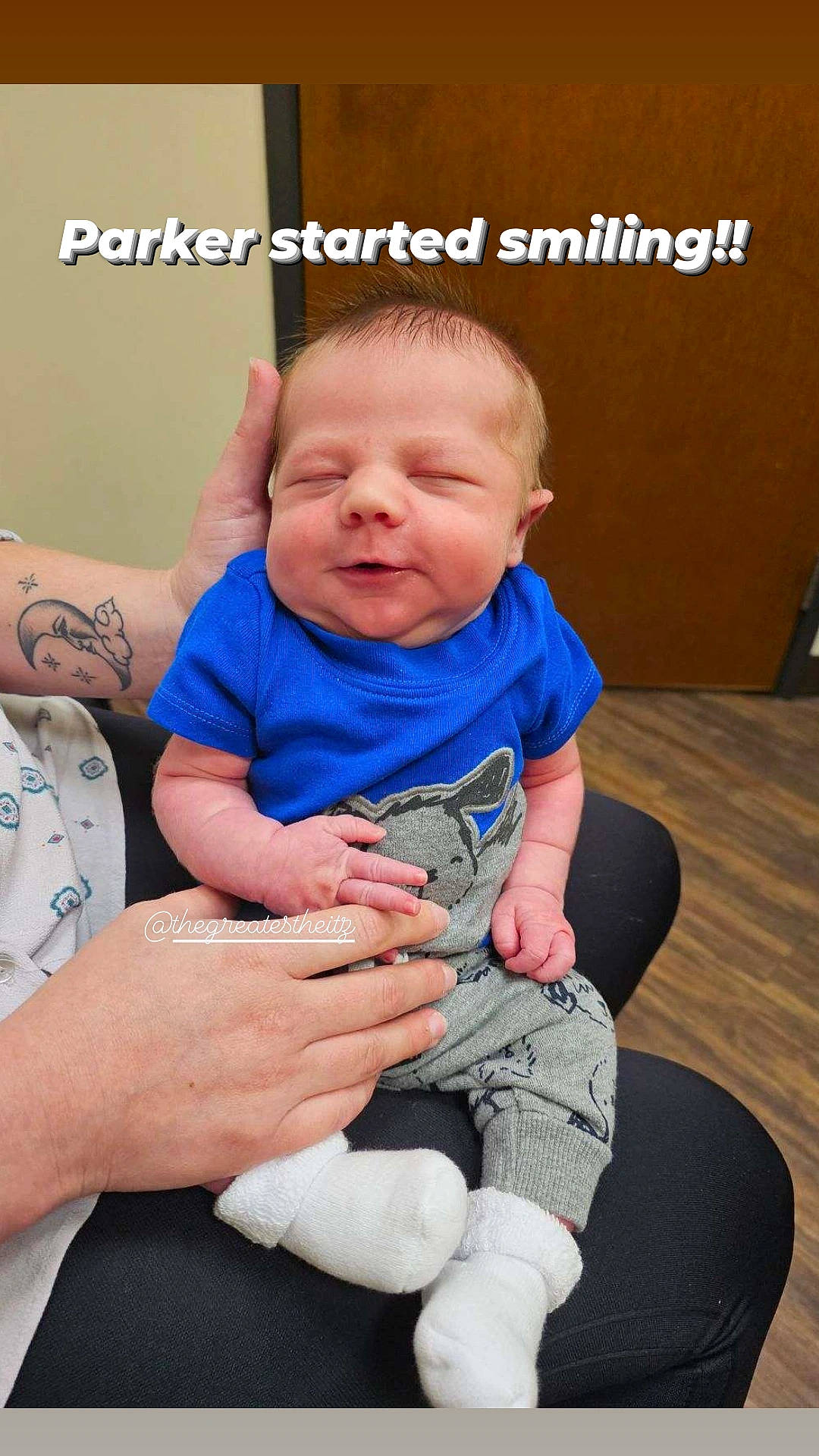 Parker is registered to the contest to win money with this photo: arm, baby, baby_toddler_clothing, child, comfort, finger, gesture, hand, happy, interaction, joint, lap, leg, mammal, mouth, person, skin, sleeve, t_shirt, thigh