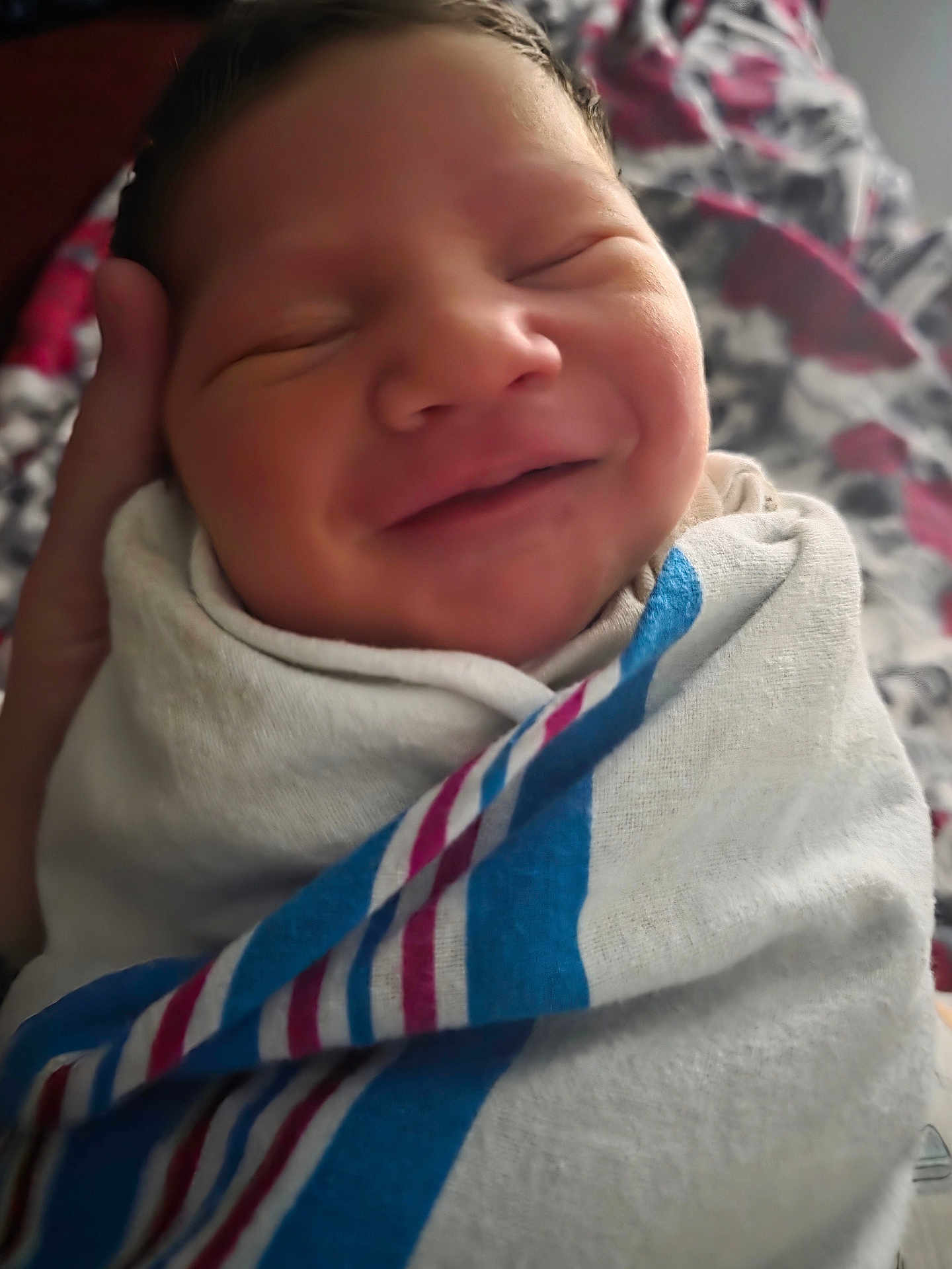 Azazel is registered to the contest to win money with this photo: newborn, baby, smile, blanket, swaddled, face, infant, hand, fabric, hospital, portrait, sleepy, cute, soft, closeup, person, bed, comfort, rest, child