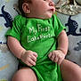 Azazel is registered to the contest to win money with this photo: baby, infant, green_onesie, blanket, dinosaur_pattern, lying_down, chubby_cheeks, hands, legs, clothing, cute, soft_texture, indoors, portrait, child, newborn, skin, face, expression, comfort