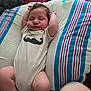 Azazel is registered to the contest to win money with this photo: baby, infant, sleeping, onesie, mustache_graphic, pillow, pacifier, blanket, arms_up, cute, resting, cozy, striped_pillow, indoor, child, peaceful, newborn, soft_lighting, portrait, relaxing