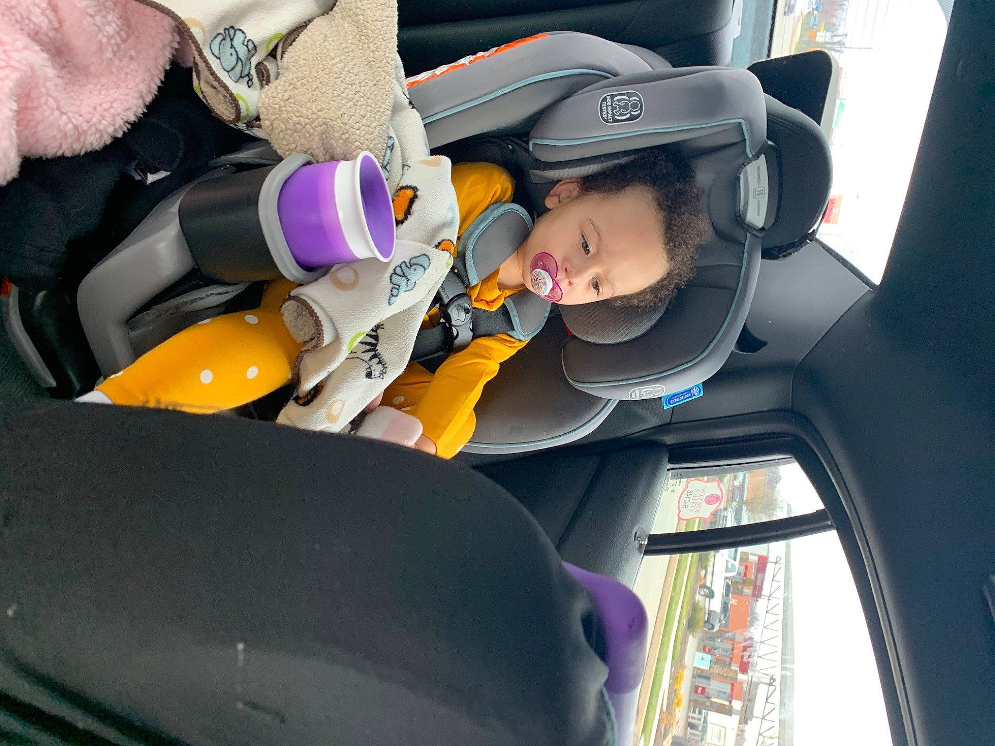 Aria is registered to the contest to win money with this photo: auto_part, automotive_design, automotive_exterior, baby, car, car_seat, car_seat_cover, comfort, family_car, head_restraint, helmet, mode_of_transport, motor_vehicle, person, seat_belt, steering_part, steering_wheel, toddler, vehicle, vehicle_door