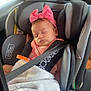 baby, car_seat, blanket, sleeping, headband, pink_bow, child, infant, seatbelt, car_interior, toddler, comfort, resting, cute, soft_light, portrait, travel, safety, young_child, peaceful