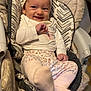 Margaux participe au concours pour gagner de l'argent avec cette photo : baby, infant, child, headband, bow, smiling, cushion, seat, clothing, socks, patterned_pants, indoor, person, cute, comfort, happy, portrait, baby_seat, foot, playful