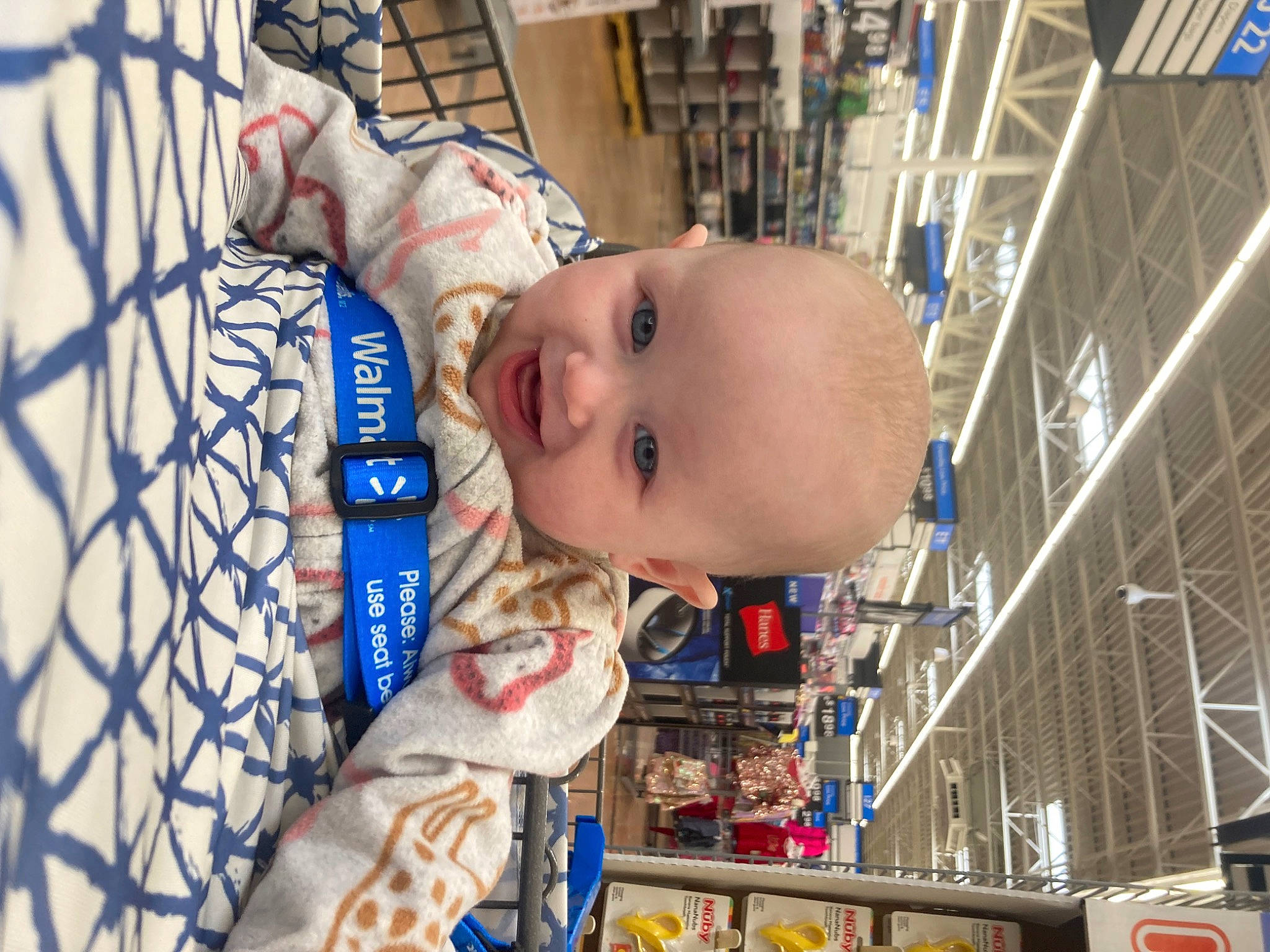 Leigha is registered to the contest to win money with this photo: baby, baby_products, baby_safety, baby_toddler_clothing, baby_toys, blue, ceiling, cheek, child, electric_blue, eye, fun, leisure, mouth, person, retail, room, shelf, smile, toddler