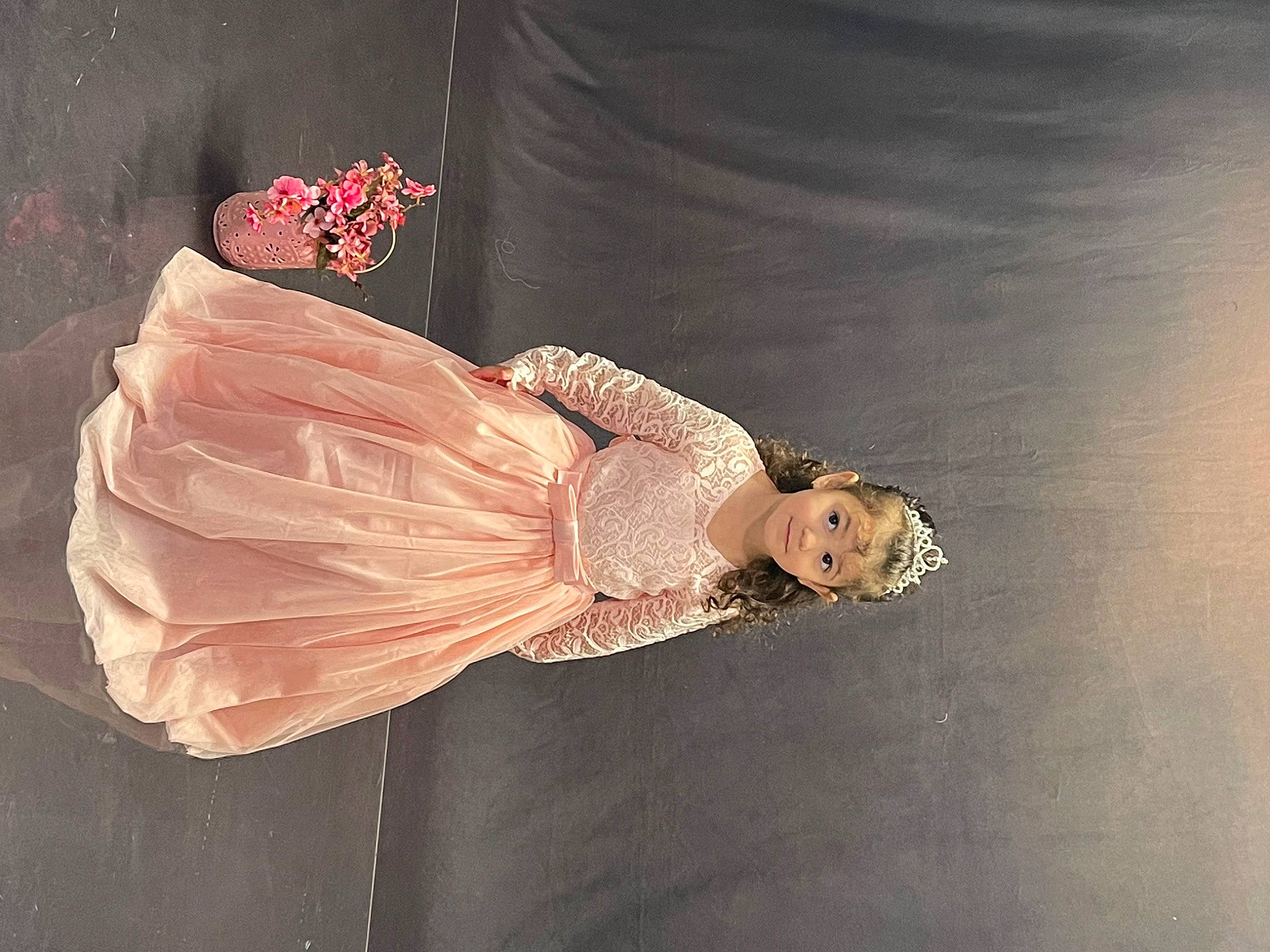 Khloe joined the competition — help win amazing prizes! arm, bridal_accessory, costume_design, day_dress, dress, embellishment, entertainment, event, fashion_accessory, fashion_design, formal_wear, gown, human_body, peach, performance_art, person, petal, sleeve, vintage_clothing, wood