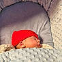 baby, baby_bed, blanket, child, comfort, cozy, cushion, cute, face, indoor, infant, knitted, newborn, peaceful, portrait, red_hat, resting, sleeping, soft_texture, warm