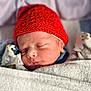 George is registered to the contest to win money with this photo: baby, blanket, child, closeup, cozy, cute, headwear, indoors, infant, knitted, newborn, peaceful, portrait, red_hat, resting, sleep, sleeping, soft_texture, warm, wrapped