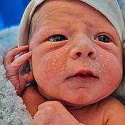 George joined the competition — help win amazing prizes! baby, blanket, child, closeup, cute, expression, eyes, face, hand, hat, indoors, infant, newborn, newborn_baby, person, portrait, skin, sleepwear, soft, wrapped