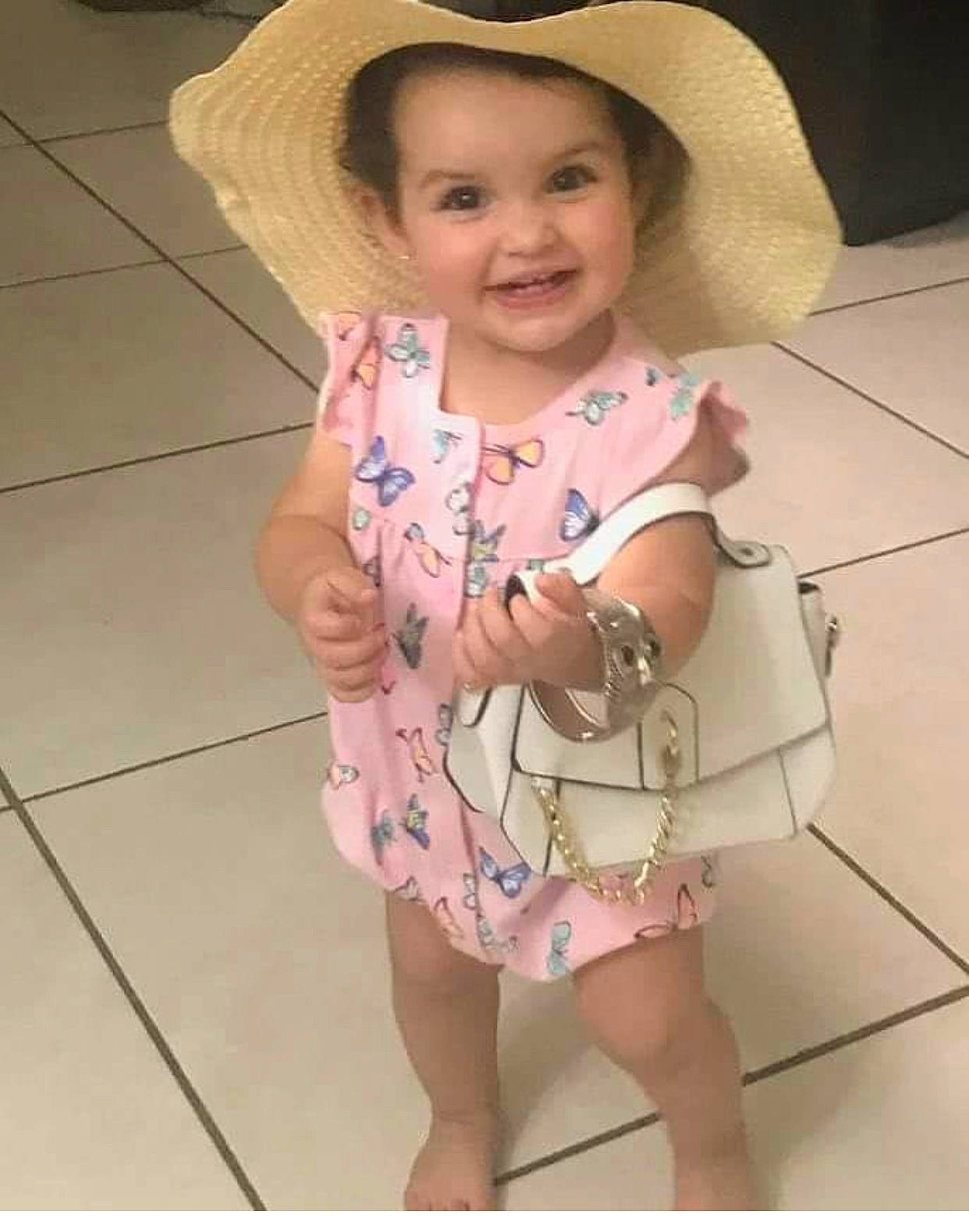 Izabella is registered to the contest to win money with this photo: baby, baby_toddler_clothing, cheek, day_dress, eye, face, flooring, fun, happy, hat, head, headgear, iris, joy, person, pink, skin, sleeve, smile, sun_hat