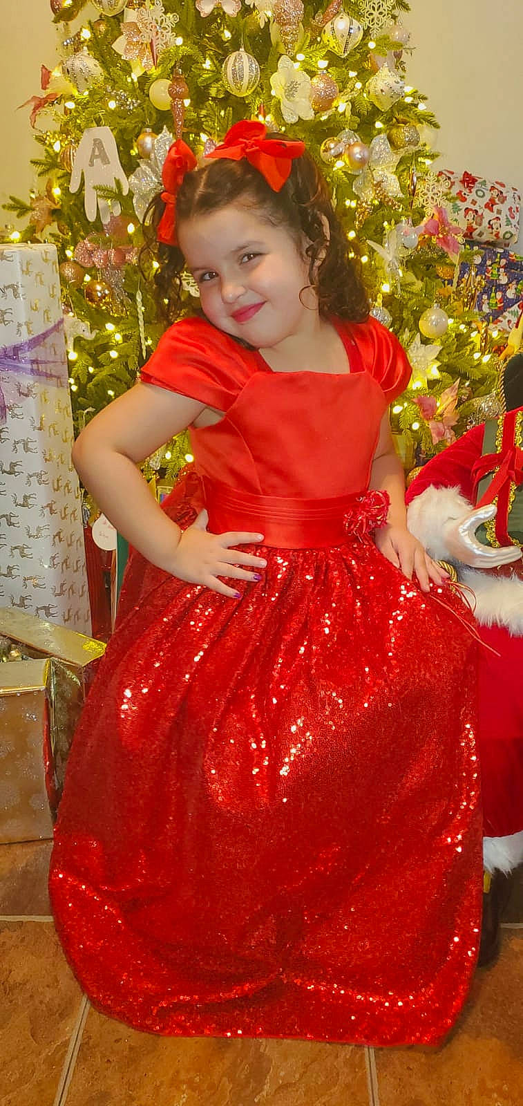 Izabella joined the competition — help win amazing prizes! christmas_decoration, christmas_ornament, christmas_tree, dress, event, formal_wear, fun, gown, happy, holiday_ornament, joy, lighting, magenta, person, pink, plant, red, smile, textile, toddler