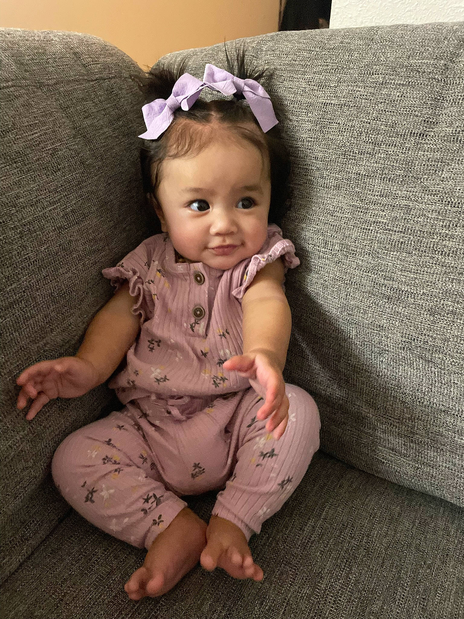 Micah is registered to the contest to win money with this photo: baby, baby_toddler_clothing, brown_hair, cheek, comfort, couch, dress, eye, eyelash, flooring, foot, hair, headband, iris, jewellery, long_hair, person, skin, sleeve, toddler