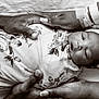 Keonna Kwe is registered to the contest to win money with this photo: newborn, baby, infant, swaddled, floral_blanket, hands, adult_hands, hospital_wristband, monochrome, black_and_white, portrait, sleepy, headwrap, closeup, family, tenderness, care, love, resting, peaceful