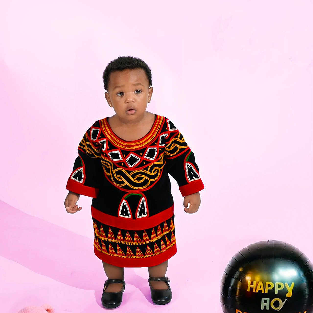 Keonna Kwe is registered to the contest to win money with this photo: balloon, birthday, cake, celebration, child, colorful, cute, face, holiday, indoors, person, pink_background, portrait, shoes, smile, standing, studio_photo, teddy_bear, toddler, traditional_clothing