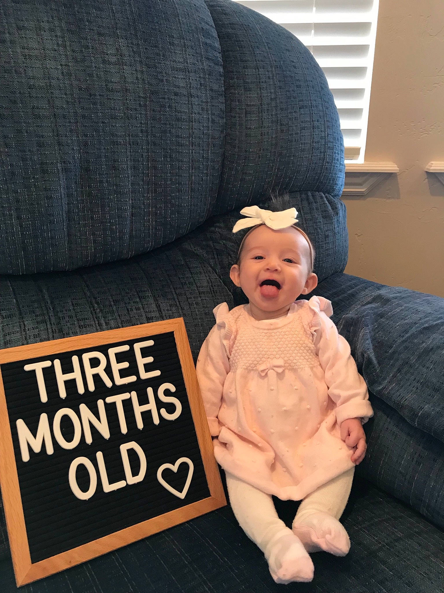 Myka joined the competition — help win amazing prizes! baby, beanie, cap, child, couch, headgear, knit_cap, person, sitting, toddler