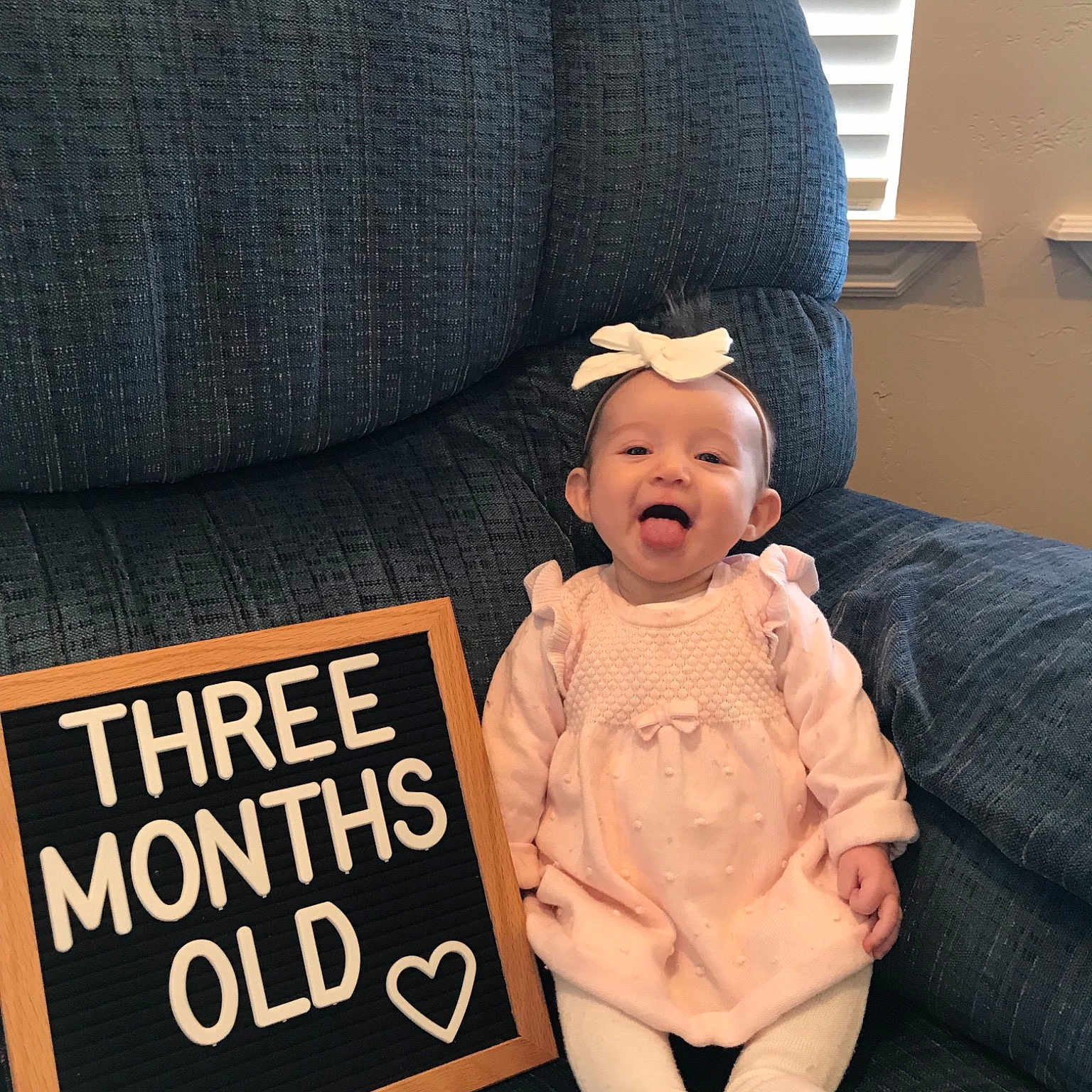 Myka joined the competition — help win amazing prizes! baby, beanie, cap, child, couch, headgear, knit_cap, person, sitting, toddler