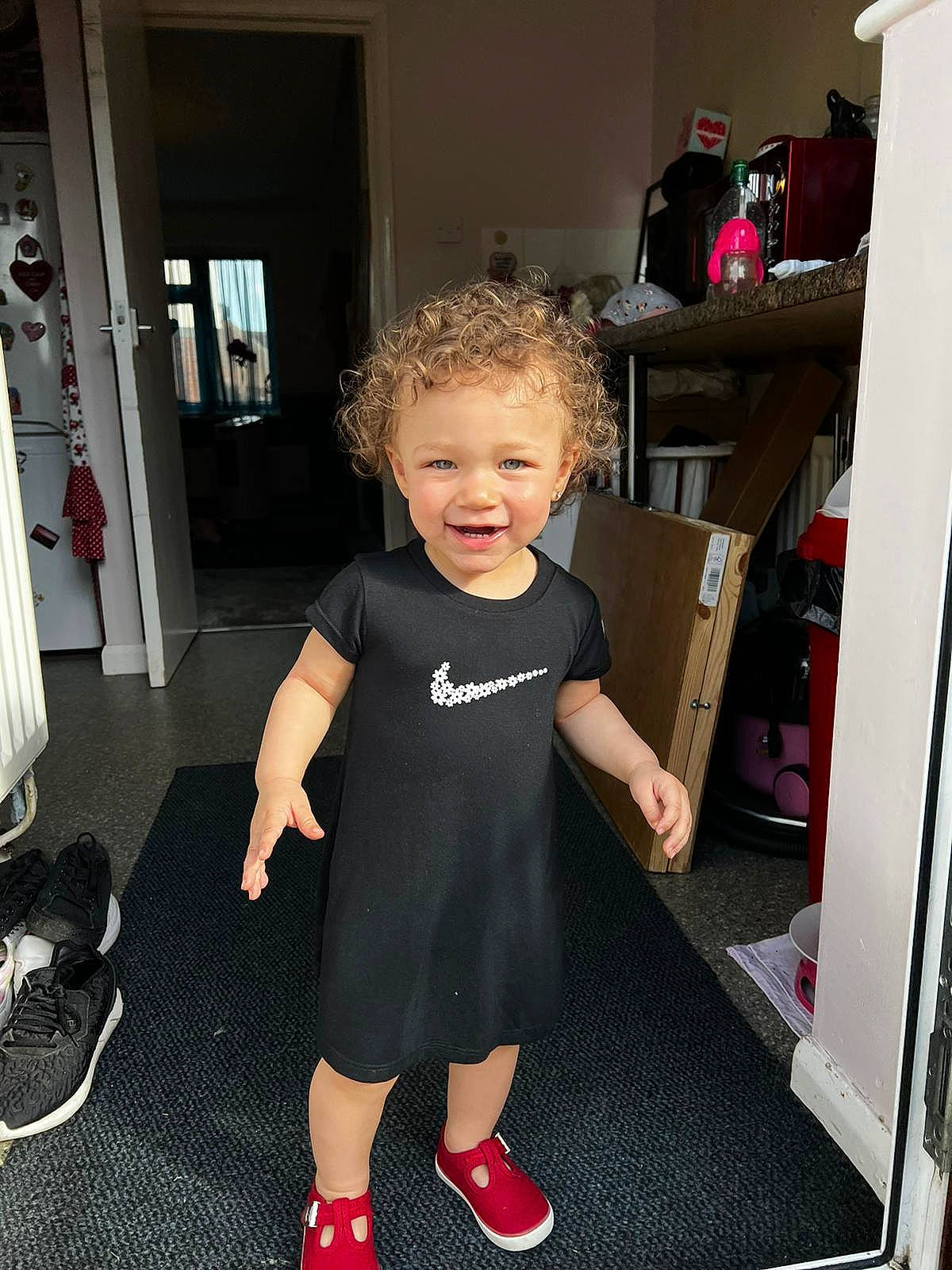 Alayah is registered to the contest to win money with this photo: baby, baby_toddler_clothing, beauty, chair, child, door, drawer, floor, flooring, fun, human_leg, joint, leg, person, sandal, shoulder, sleeve, smile, standing, t_shirt