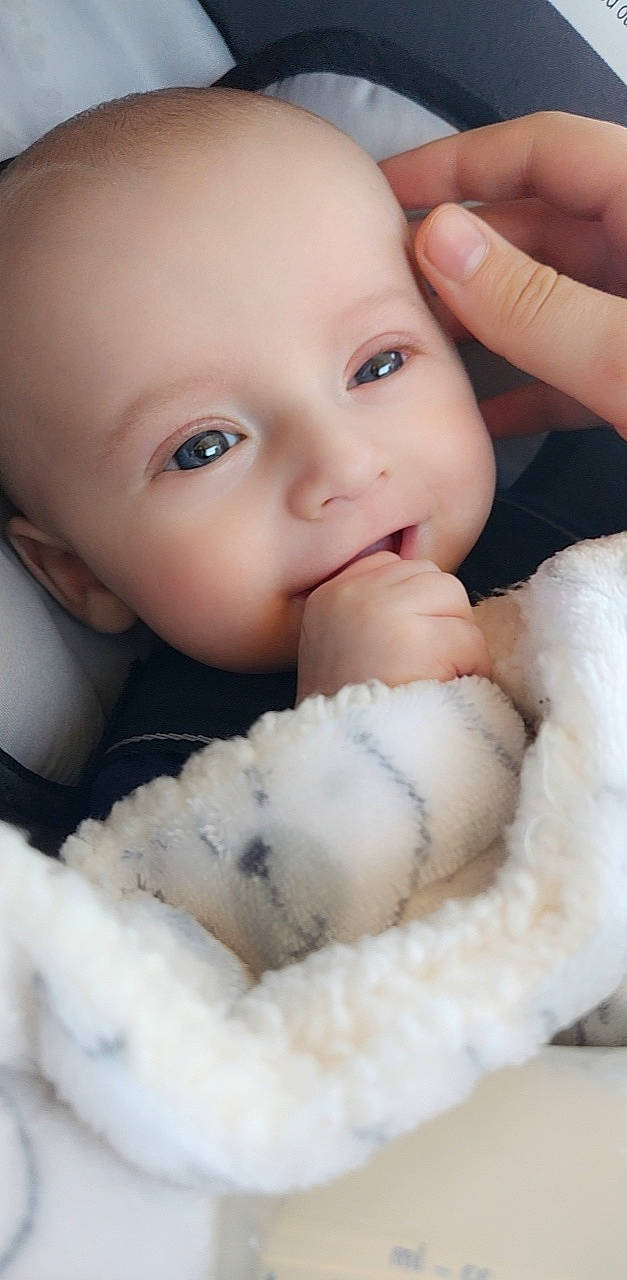 Denis is registered to the contest to win money with this photo: baby, baby_toddler_clothing, cheek, child, eyelash, facial_expression, finger, flash_photography, gesture, hand, happy, lip, mouth, nail, nose, organ, person, skin, textile, thumb